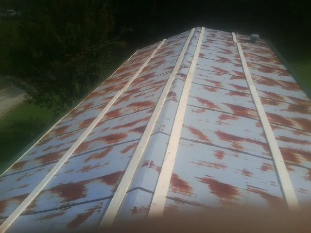 Rusted metal roof panels with new wood purlins before replacement — Storm Damage Roof Repair in Little Silver by Roofing Brothers