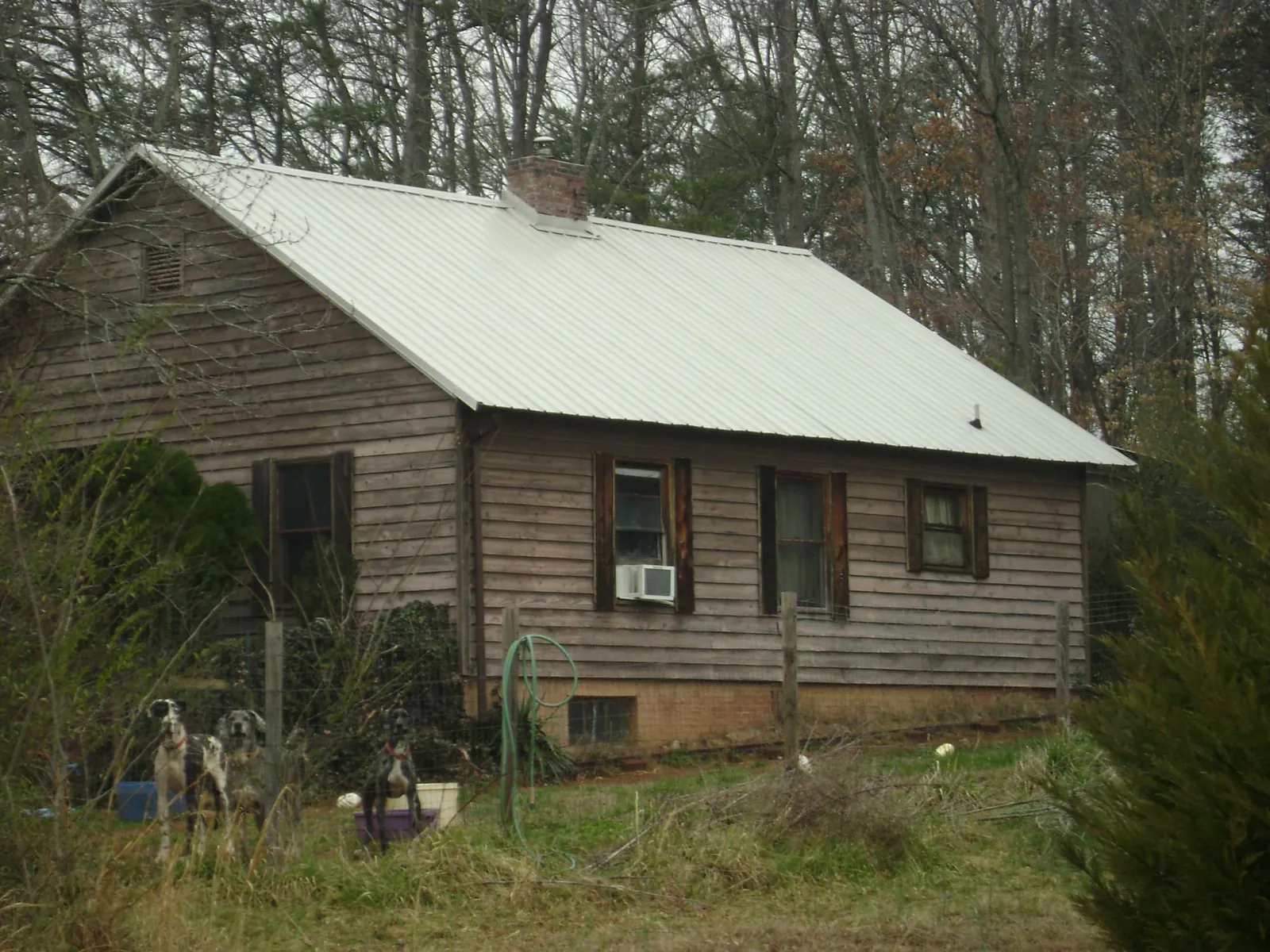 White metal roof on an old wood sided farmhouse, from a Metal Roof Installation job in Little Silver